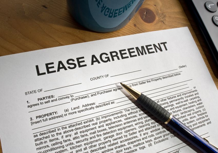 a lease agreement document with a pen on it